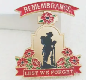 Memorial plaque with silhouette of a soldier, flowers, and 'Remembrance Lest We Forget' text on a white background.
